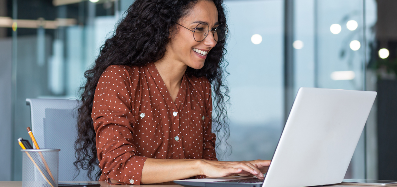 A hispanic woman working in a modern office setting
